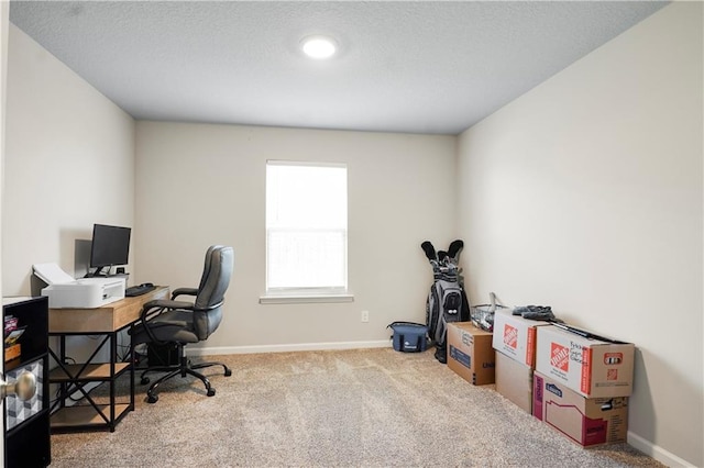 carpeted home office featuring baseboards