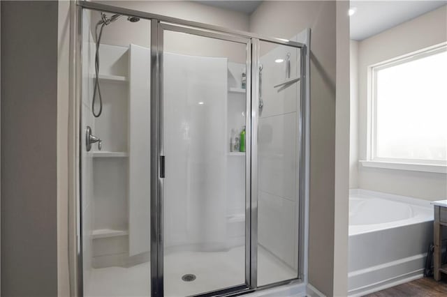 full bath featuring a stall shower and a garden tub