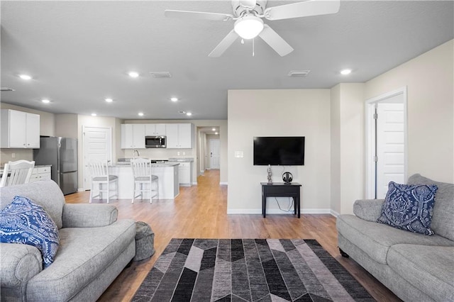 living room with recessed lighting and light wood finished floors