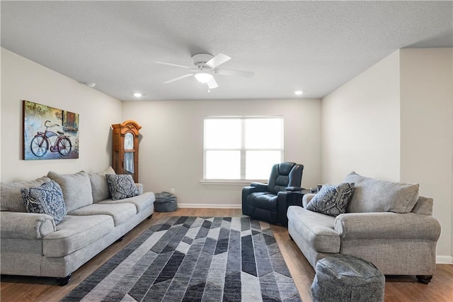 living room with baseboards, ceiling fan, dark wood-type flooring, a textured ceiling, and recessed lighting