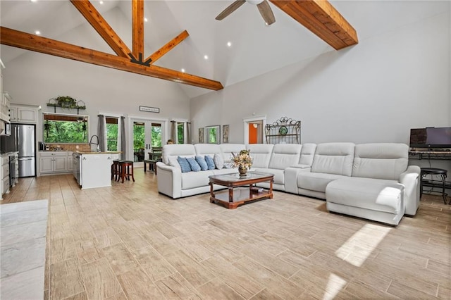 living area with recessed lighting, a ceiling fan, beam ceiling, and high vaulted ceiling