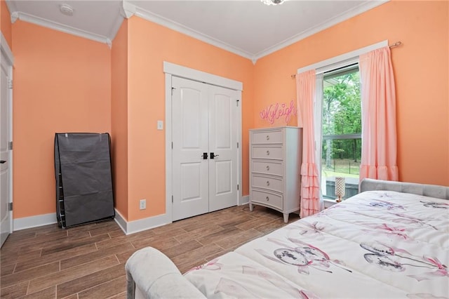 bedroom with baseboards, ornamental molding, and wood tiled floor
