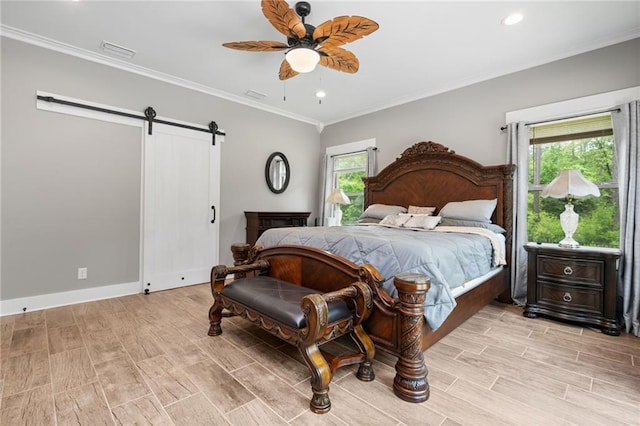 bedroom featuring visible vents, ornamental molding, a barn door, a ceiling fan, and light wood finished floors