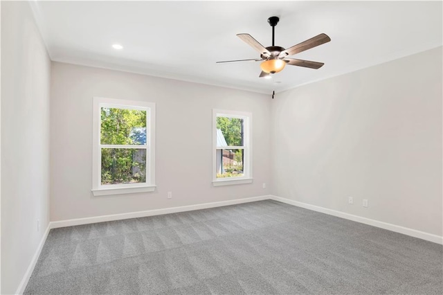 unfurnished room with a healthy amount of sunlight, baseboards, a ceiling fan, and carpet flooring
