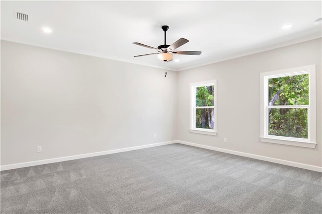 empty room with carpet flooring, a ceiling fan, baseboards, recessed lighting, and visible vents