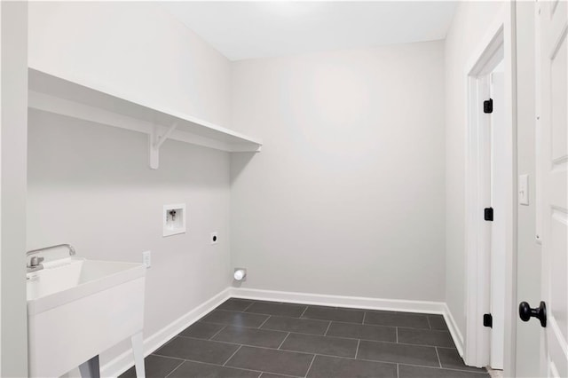 clothes washing area featuring hookup for an electric dryer, laundry area, a sink, baseboards, and hookup for a washing machine