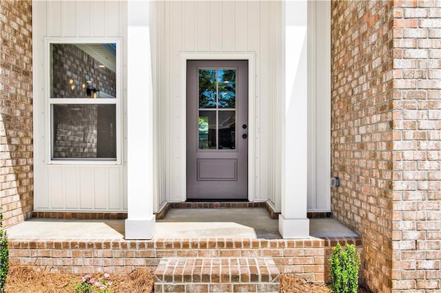 entrance to property featuring board and batten siding