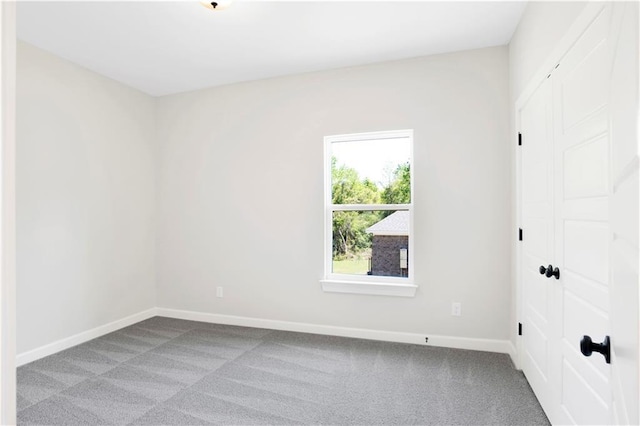 carpeted empty room with baseboards