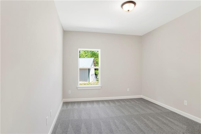 empty room with carpet floors and baseboards