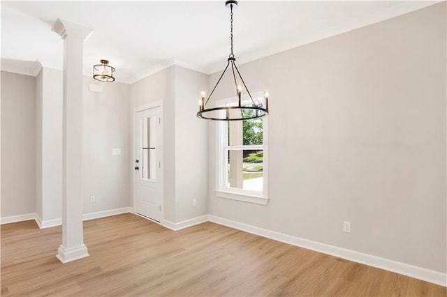 unfurnished dining area featuring crown molding, baseboards, an inviting chandelier, and light wood-type flooring