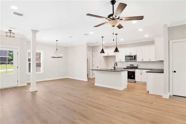 kitchen featuring dark countertops, stainless steel appliances, open floor plan, and visible vents