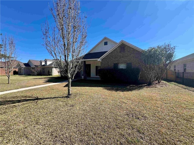 view of front facade with fence and a front yard