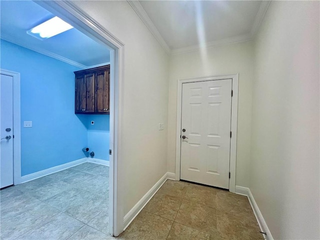 washroom with cabinet space, baseboards, and crown molding