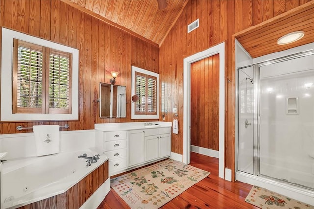 34460 Steelwood Ridge Rd, Loxley, AL 36551 - bathroom featuring a stall shower, a whirlpool tub, vaulted ceiling, wood ceiling, and wood finished floors