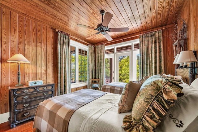 34460 Steelwood Ridge Rd, Loxley, AL 36551 - bedroom featuring wood ceiling, wooden walls, access to exterior, wood finished floors, and a ceiling fan