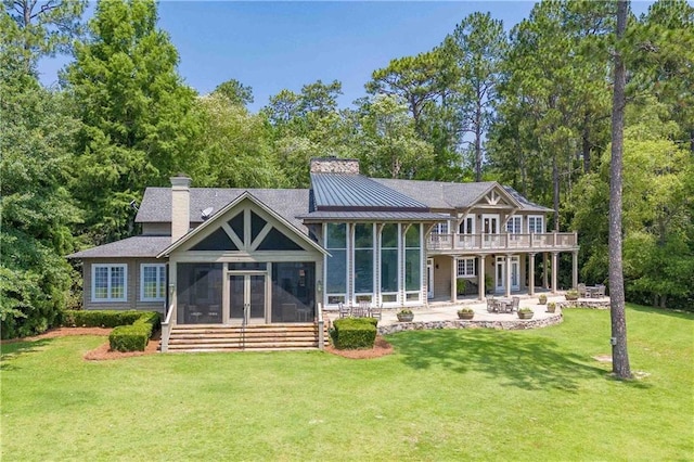 34460 Steelwood Ridge Rd, Loxley, AL 36551 - back of property featuring a sunroom, a lawn, a chimney, a patio area, and a wooden deck