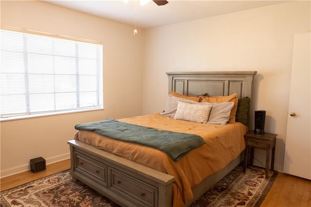 bedroom featuring ceiling fan and dark hardwood / wood-style flooring