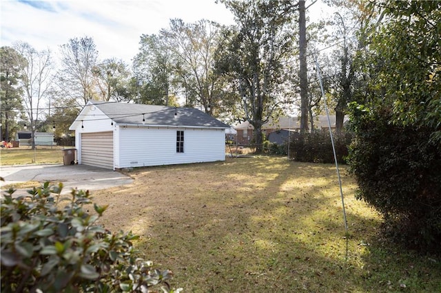 view of yard with a garage and an outdoor structure