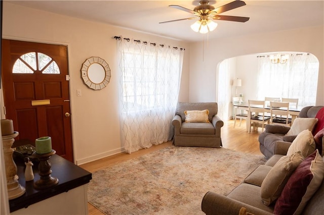 living room featuring ceiling fan and light hardwood / wood-style floors