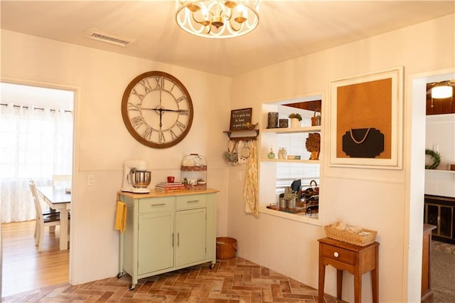 bar featuring a notable chandelier and green cabinetry