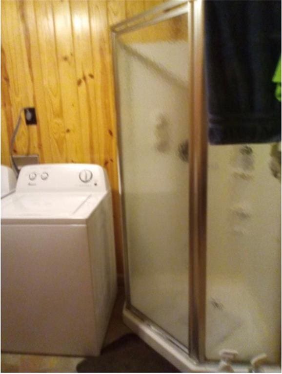 washroom featuring wood walls and washer / clothes dryer