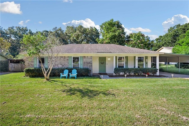 ranch-style home with covered porch, a front yard, and a carport