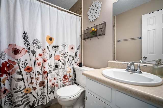 bathroom featuring a textured ceiling, walk in shower, vanity, and toilet