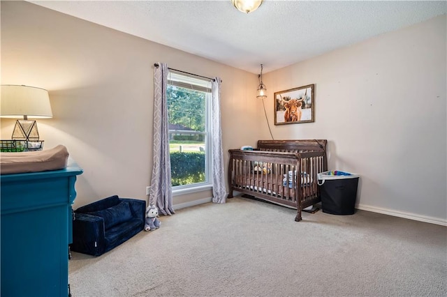 bedroom with a crib and carpet