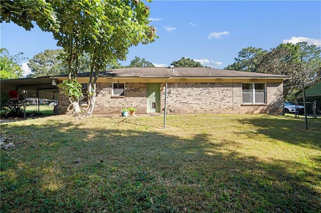 rear view of property with a yard