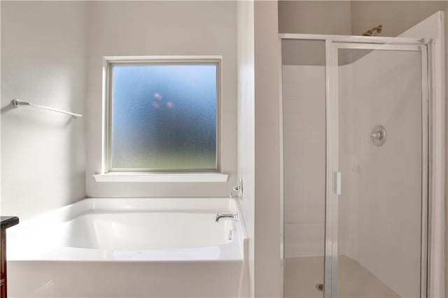 full bath featuring a shower stall, vanity, and a bath