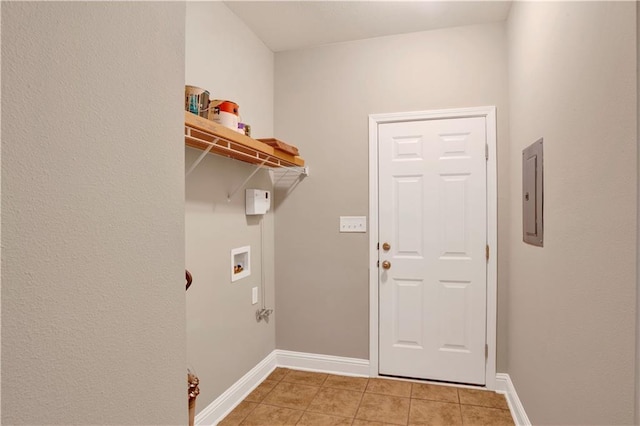 clothes washing area featuring laundry area, hookup for a washing machine, baseboards, and light tile patterned floors