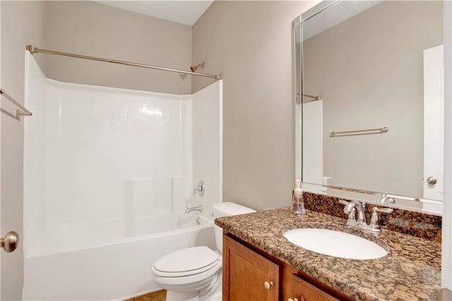 bathroom featuring tub / shower combination, vanity, and toilet