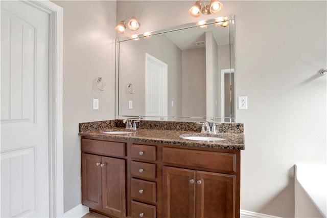 bathroom with double vanity and a sink