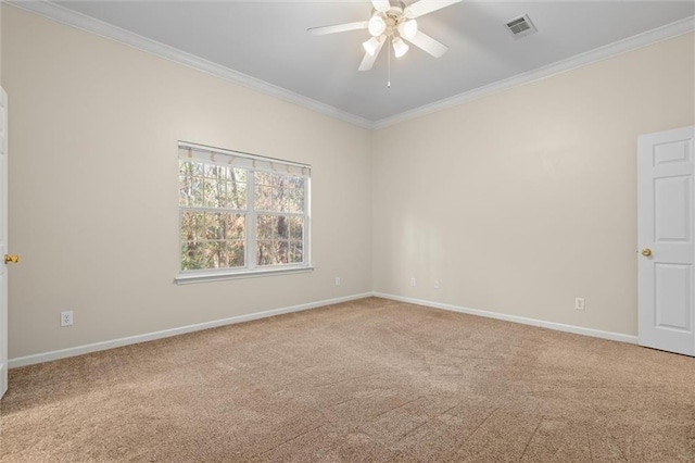 empty room featuring ceiling fan, carpet floors, and crown molding