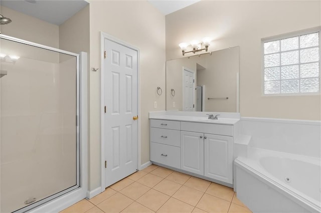 bathroom featuring plus walk in shower, vanity, and tile patterned floors