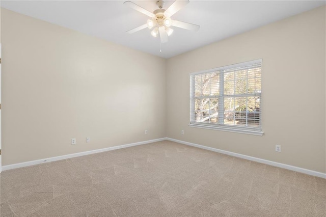 empty room with light colored carpet and ceiling fan