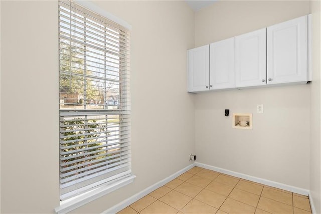 washroom with hookup for a washing machine, plenty of natural light, cabinets, and hookup for an electric dryer