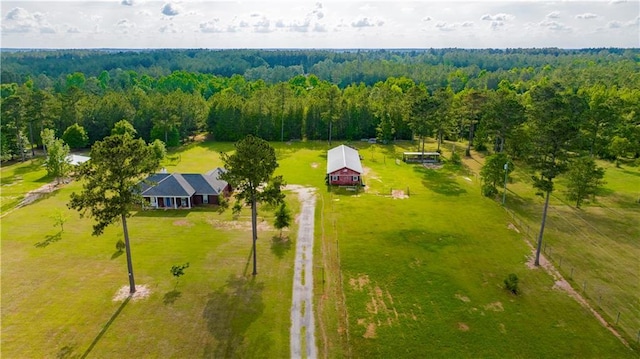 birds eye view of property featuring a forest view