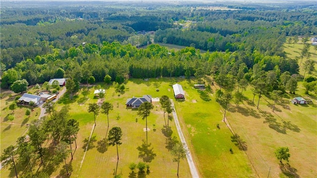 birds eye view of property featuring a forest view
