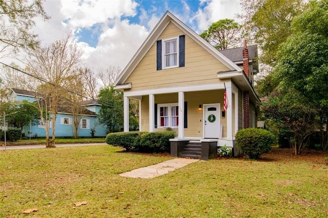 bungalow-style house featuring a front lawn and a porch