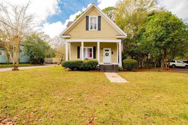 bungalow with a front yard and a porch