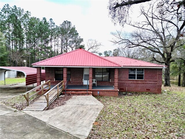 6830 Freedom Ln, Eight Mile, AL 36613 - ranch-style house featuring covered porch, a carport, metal roof, and brick siding