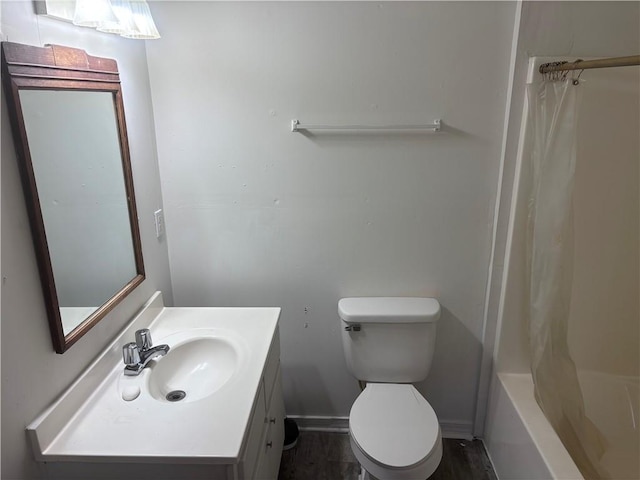 full bathroom with vanity, shower / tub combo, and toilet