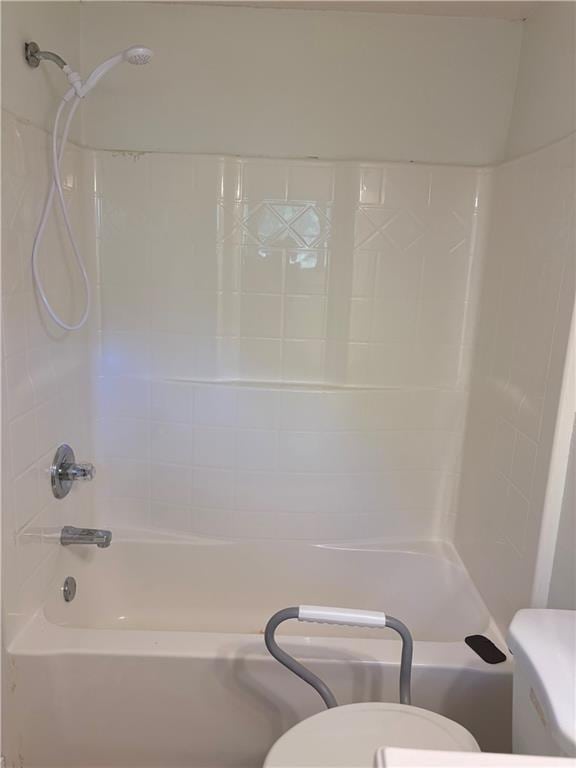 bathroom featuring  shower combination and toilet