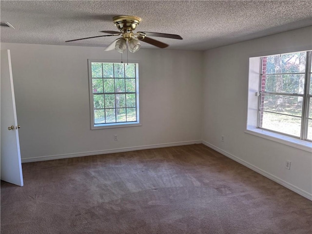 carpeted spare room featuring ceiling fan and a textured ceiling