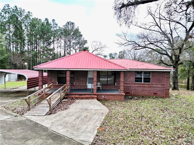 ranch-style home with a carport and covered porch