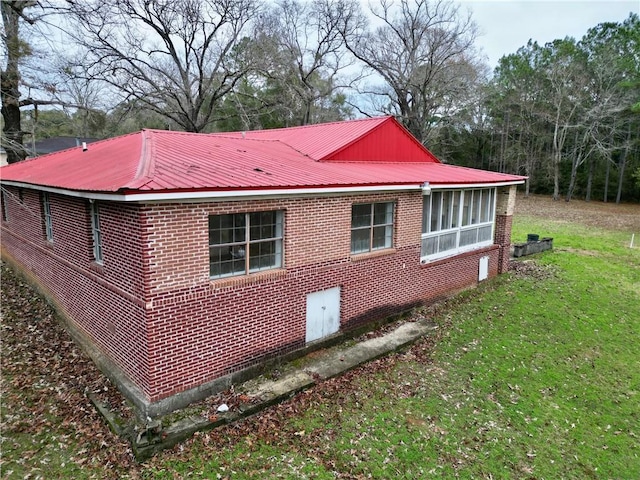 6830 Freedom Ln, Eight Mile, AL 36613 - view of side of property featuring brick siding, metal roof, and a lawn