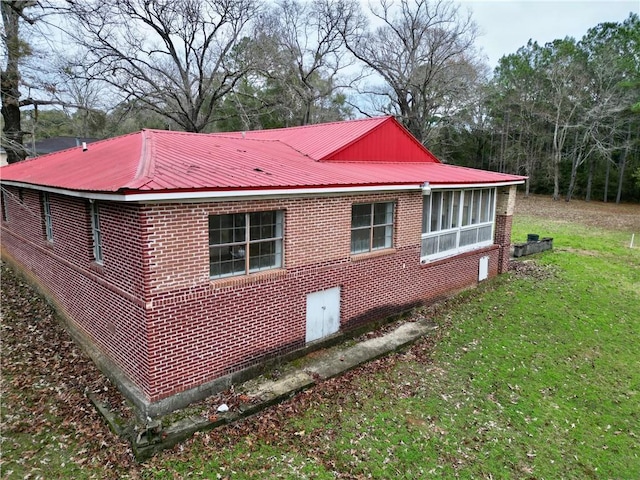 view of property exterior with a lawn