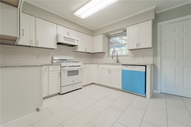 kitchen with white appliances, tasteful backsplash, sink, and white cabinets