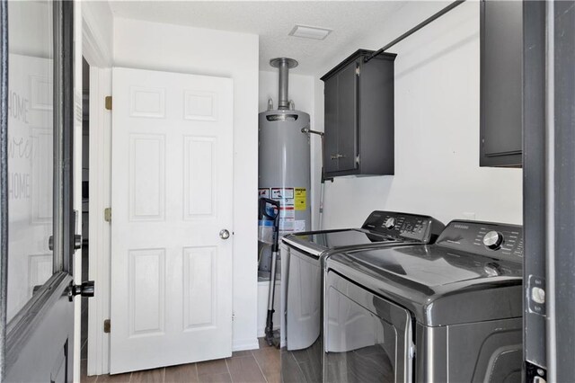 13310 August Dr, Mobile, AL 36695 - washroom featuring washer and dryer, cabinet space, and gas water heater